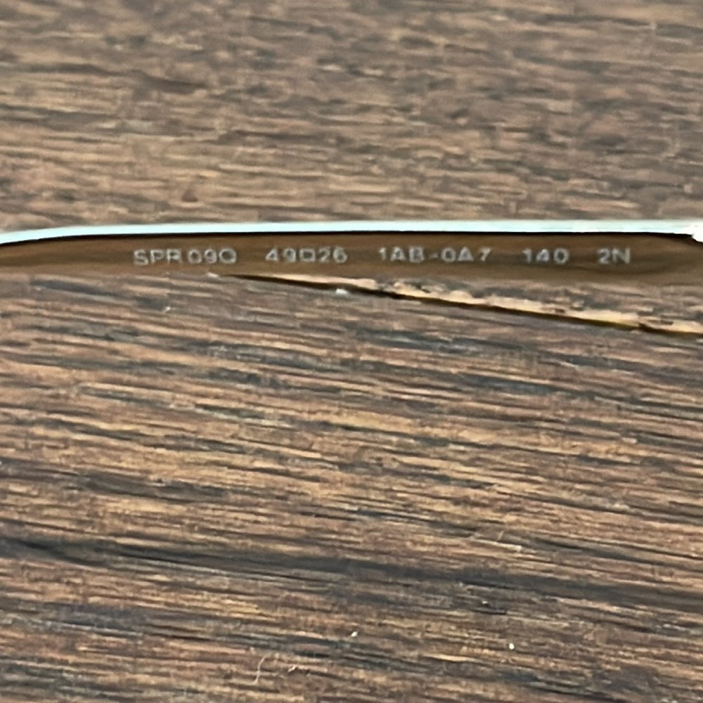 Prada Women’s Black and Gold Sunglasses